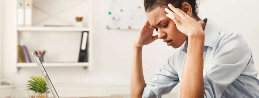 Female office worker with headache